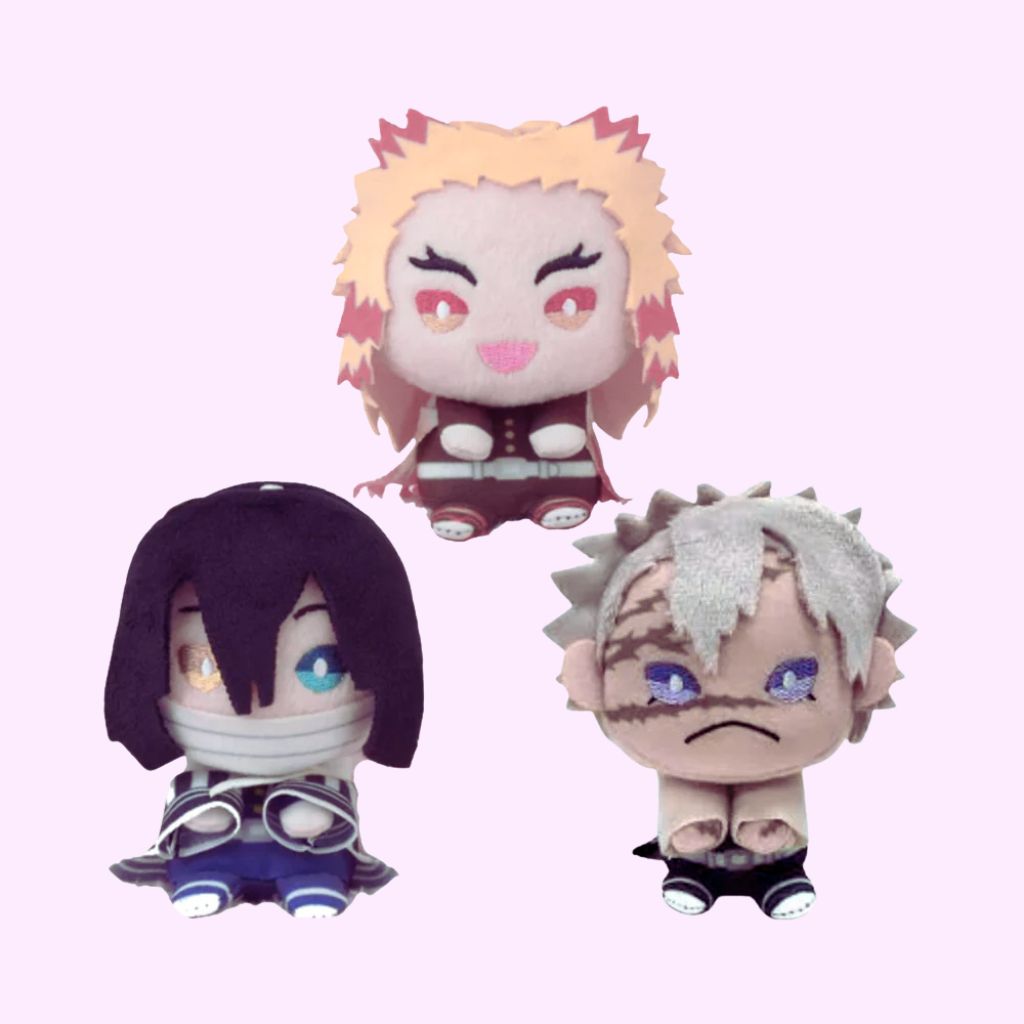 Three anime-style plush toys with different hairstyles and colors on a light pink background