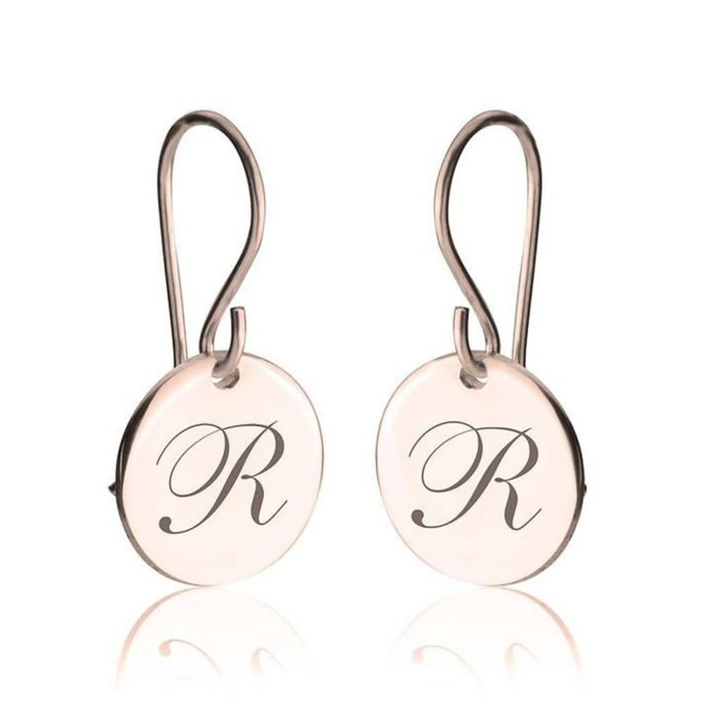 Pair of earrings with 'R' initials on a white background