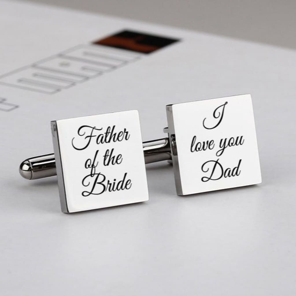 Cufflinks with 'Father of the Bride' and 'I love you Dad' text on a newspaper background
