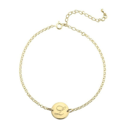 Gold bracelet with a round tag featuring the letter 'L' on a white background