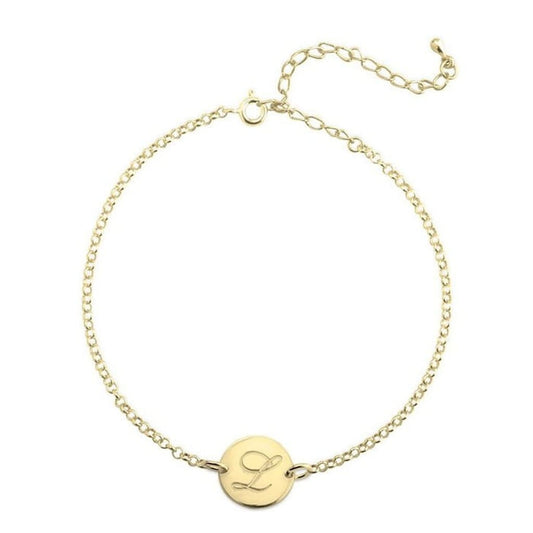 Gold bracelet with a round tag featuring the letter 'L' on a white background