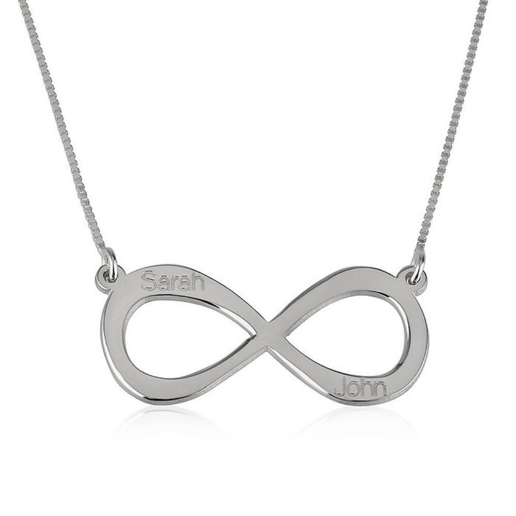 Silver infinity necklace with engraved names on a white background