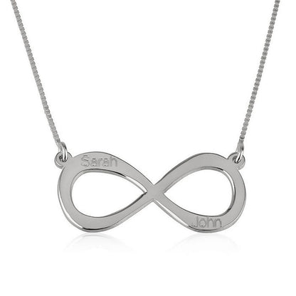 Silver infinity necklace with engraved names on a white background