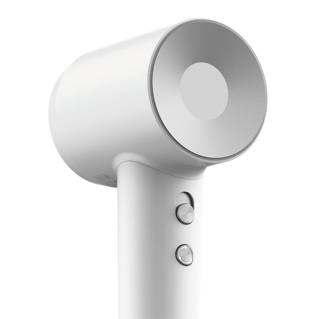 White hair dryer with a focus on the nozzle and control panel on a white background