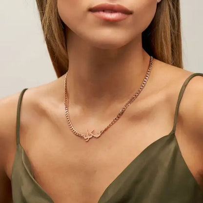 Rose gold necklace worn by a model against a neutral background