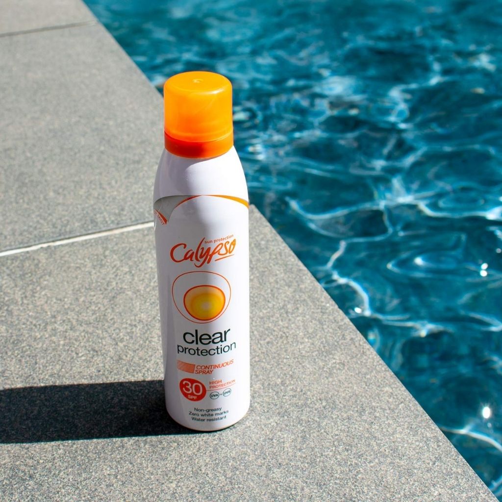 Calypso sunscreen spray bottle by a pool
