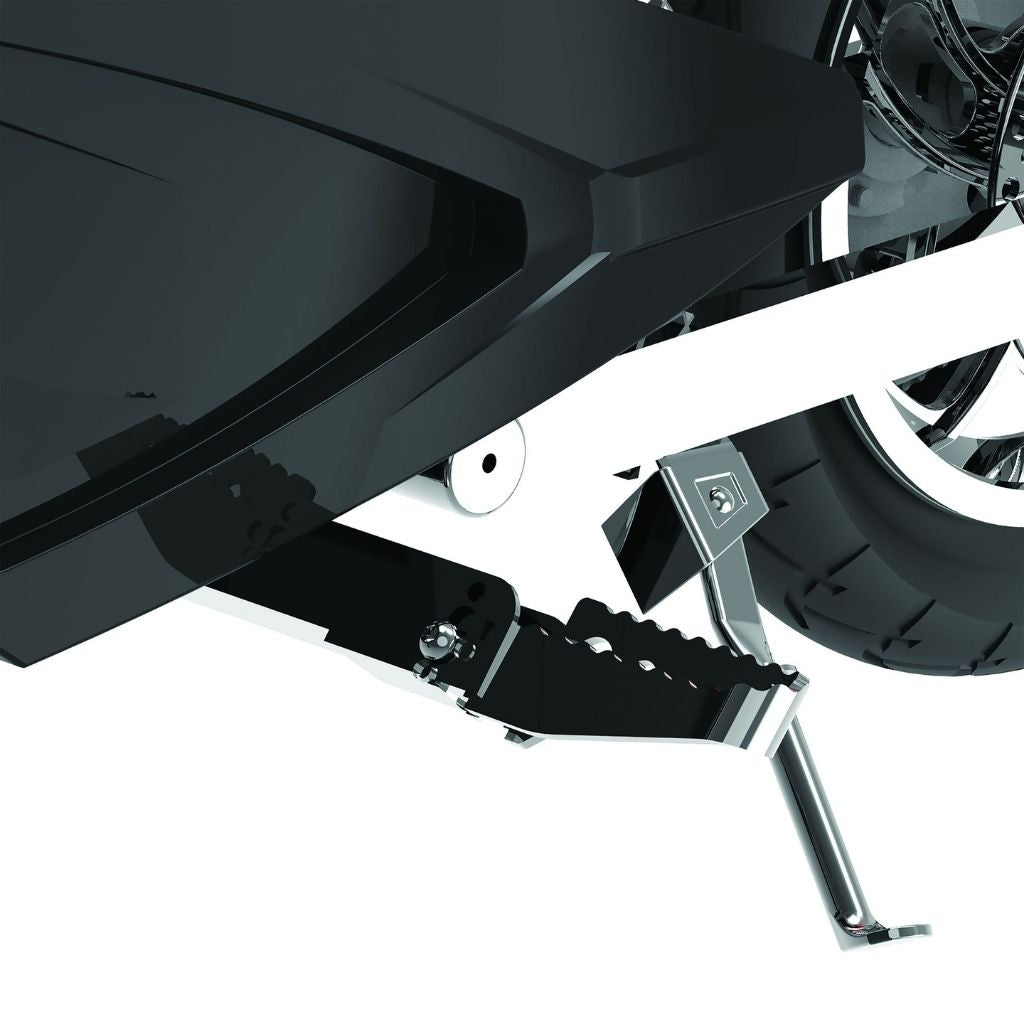 Close-up of a motorcycle's foot peg and rear wheel on a white background