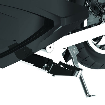 Close-up of a motorcycle's foot peg and rear wheel on a white background
