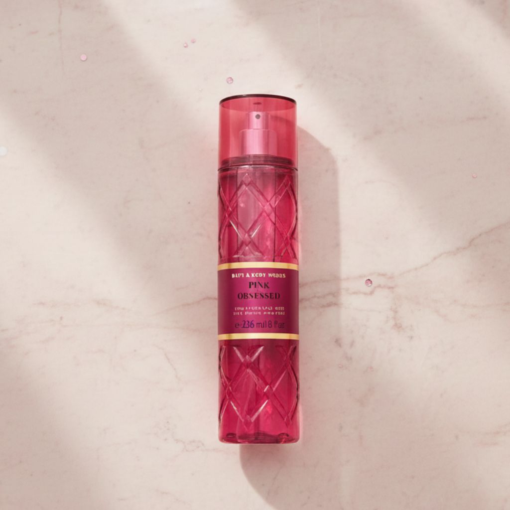 Red spray bottle with decorative pattern on a beige marble background