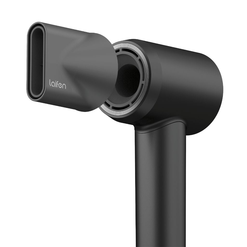 Black hair dryer with nozzle attachment on a white background