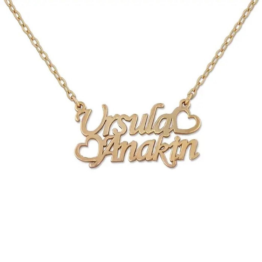 Gold name necklace with 'Ursula' and 'Anaktin' on a white background