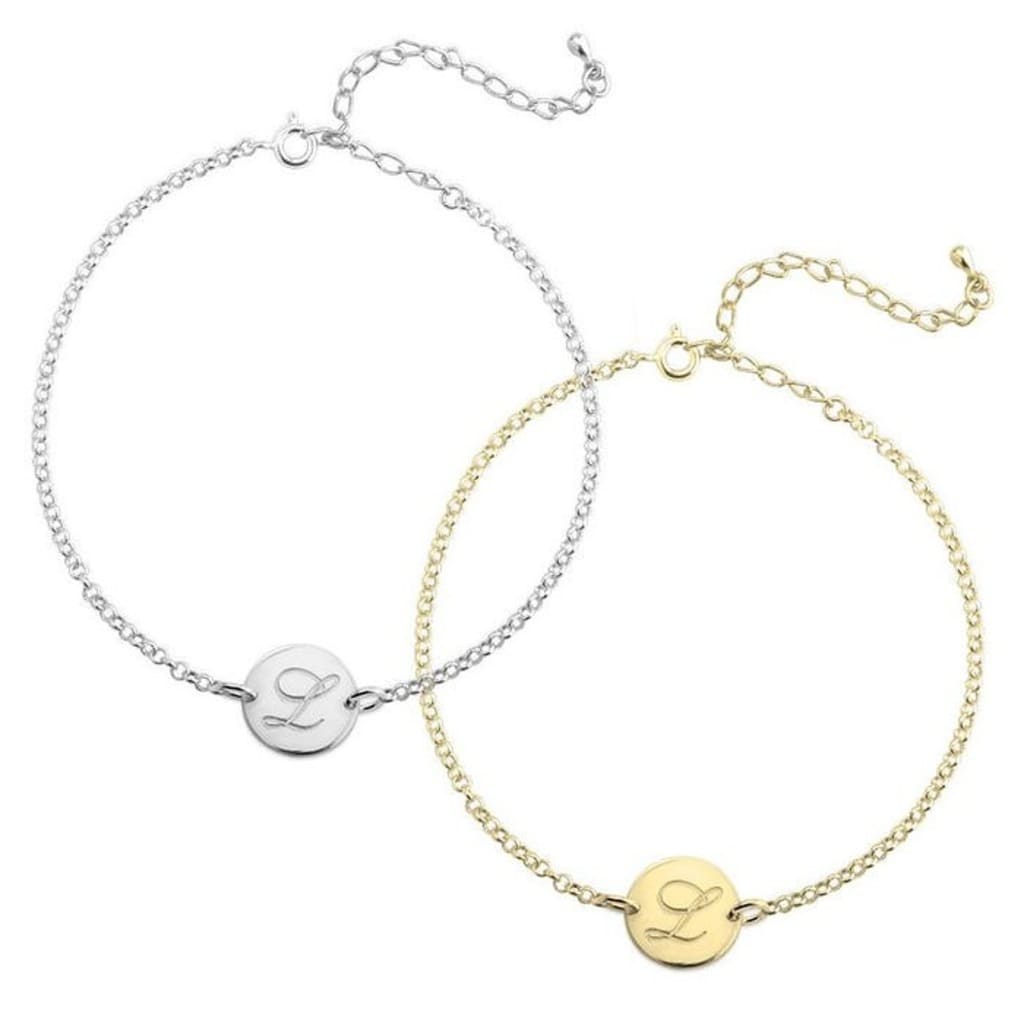Two gold and silver bracelets with circular pendants on a white background