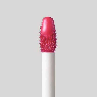 Lipstick with a spiky texture on a light gray background