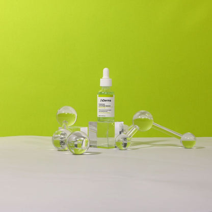 Skincare products including a dropper bottle and roller on a green background