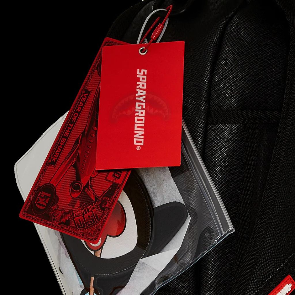 Black leather jacket with a red 'Sprayground' tag and red money-themed card on a black background