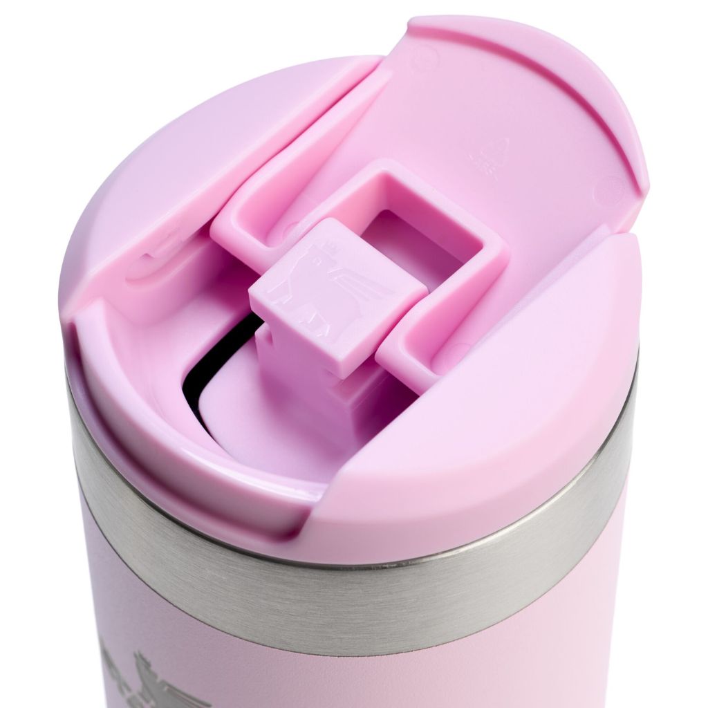 Pink travel mug with a silver base on a white background