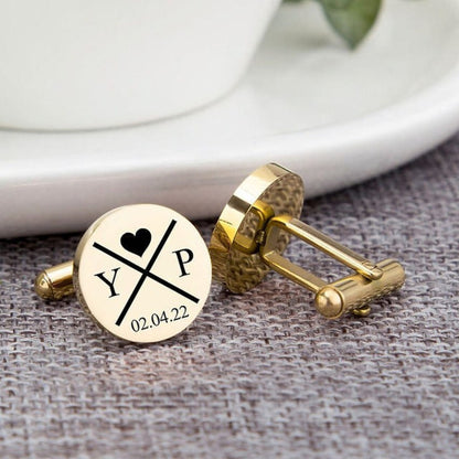 Gold cufflinks with personalized design on a textured surface