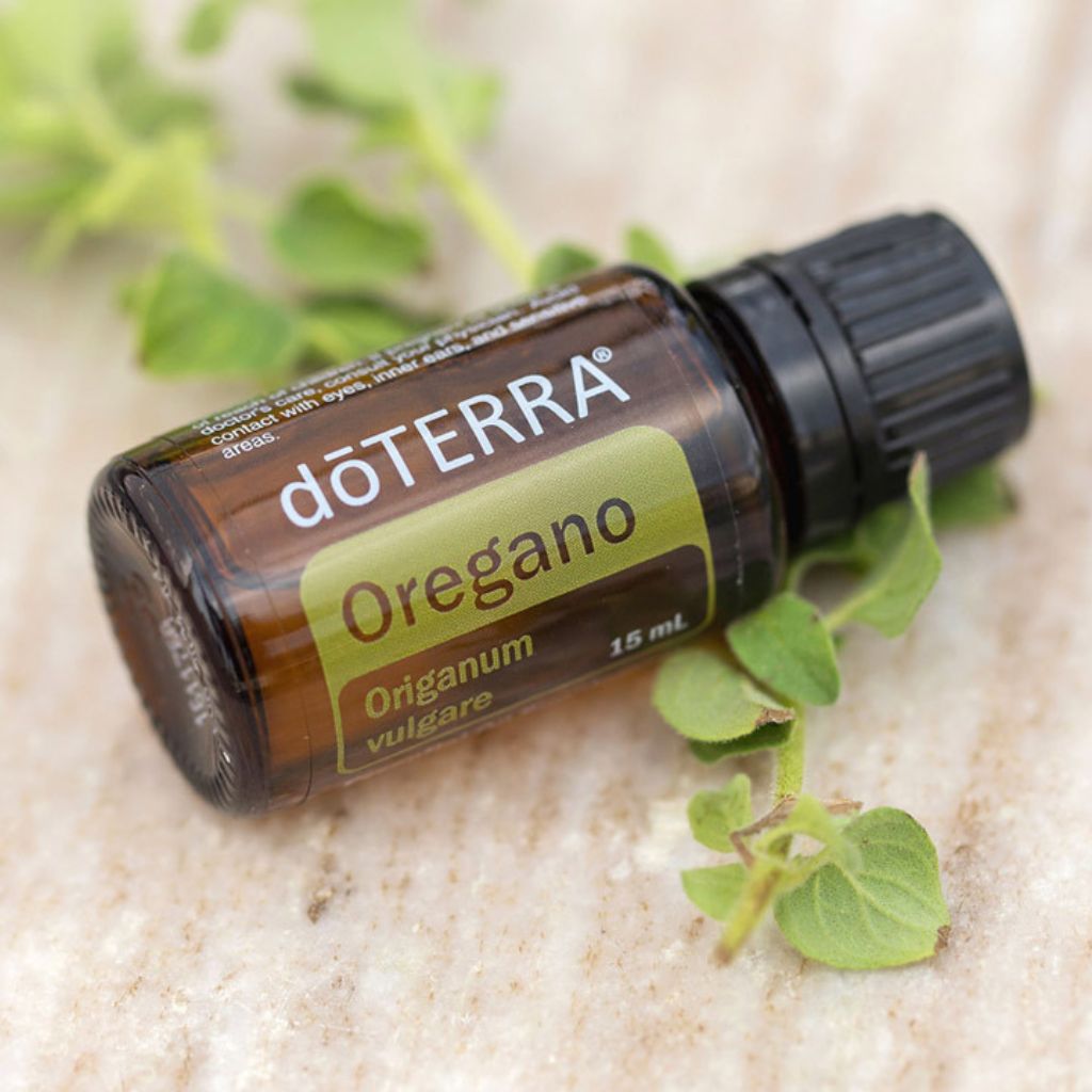 doTERRA Oregano essential oil bottle with oregano leaves on a light background