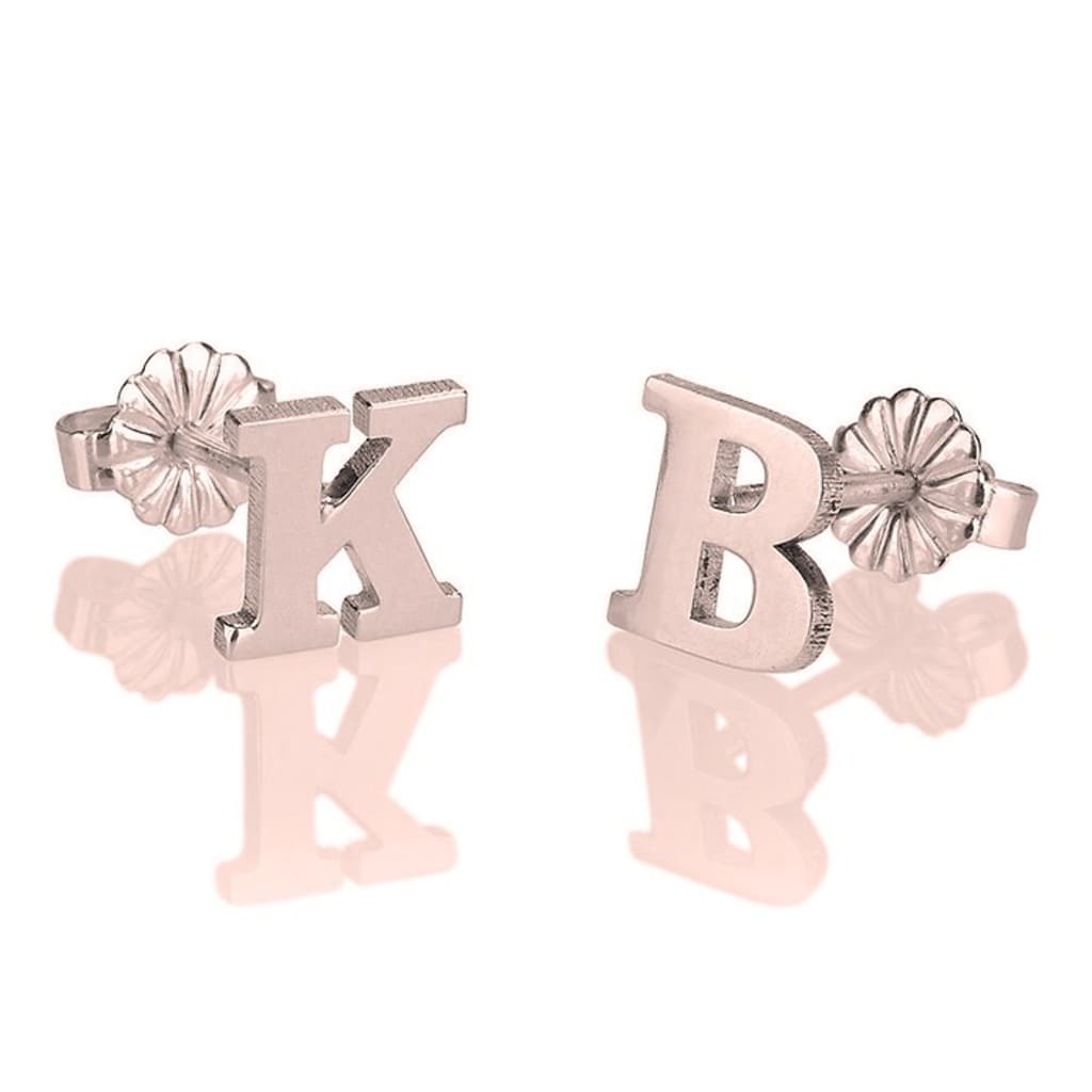 Pair of letter 'K' and 'B' earrings on a white background
