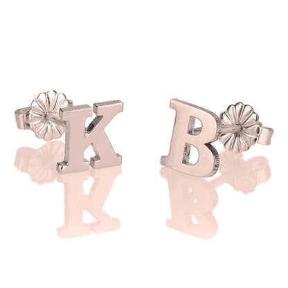 Pair of letter 'K' and 'B' earrings on a white background