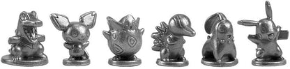 Set of six metallic figurines resembling Pokémon characters on a white background