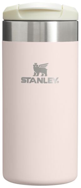 Stanley insulated tumbler with a white lid on a light pink background