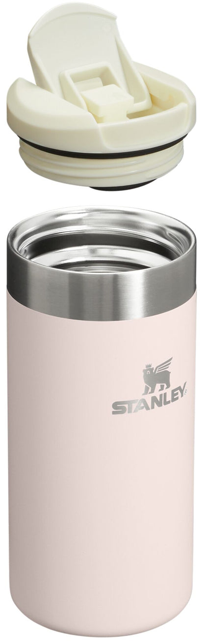 Pink Stanley tumbler with a white lid on a white background