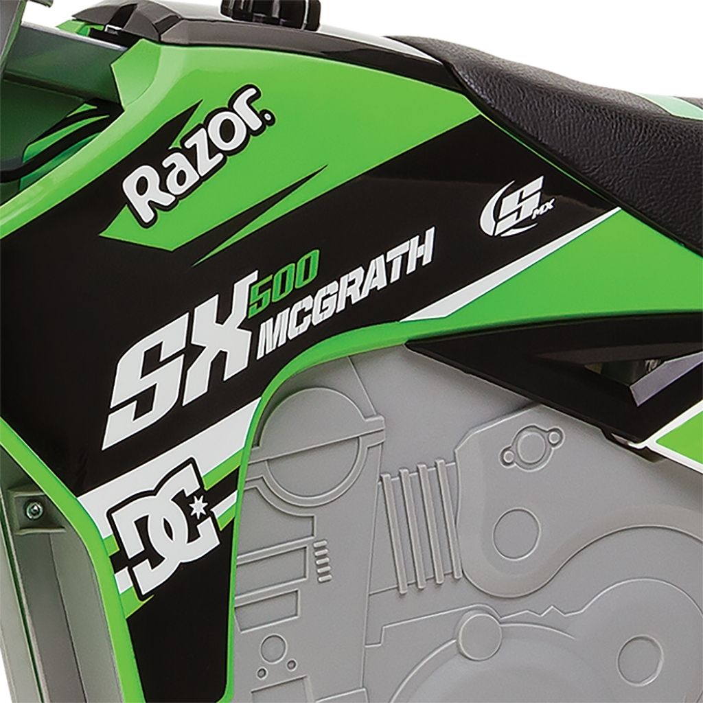 Close-up of a green and black Razor SX500 McGrath toy bike with branding.