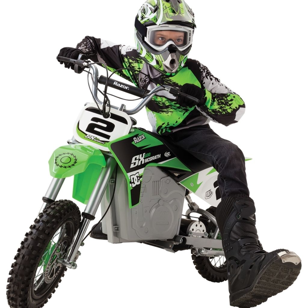 Child on a green and white dirt bike with a helmet and goggles, on a white background