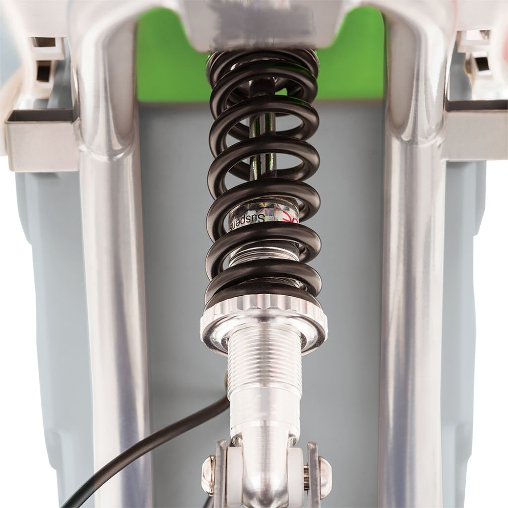 Close-up of a suspension fork with coil spring on a motorcycle, featuring the brand 'Showa'.
