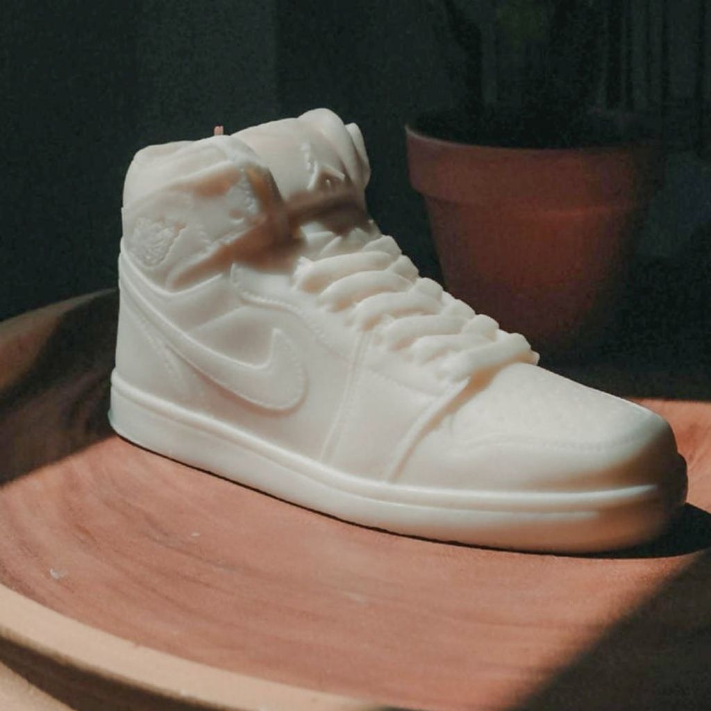 White sneaker with a Nike logo on a wooden surface
