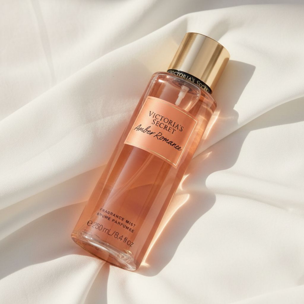 Victoria's Secret Amber Romance fragrance mist bottle on a white fabric background