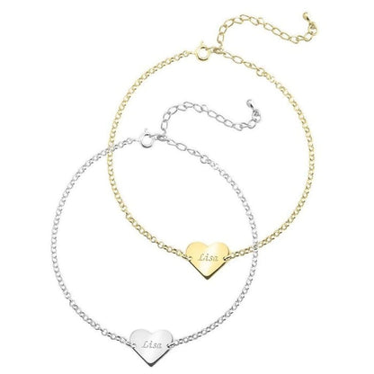 Two heart-shaped gold and silver necklaces on a white background