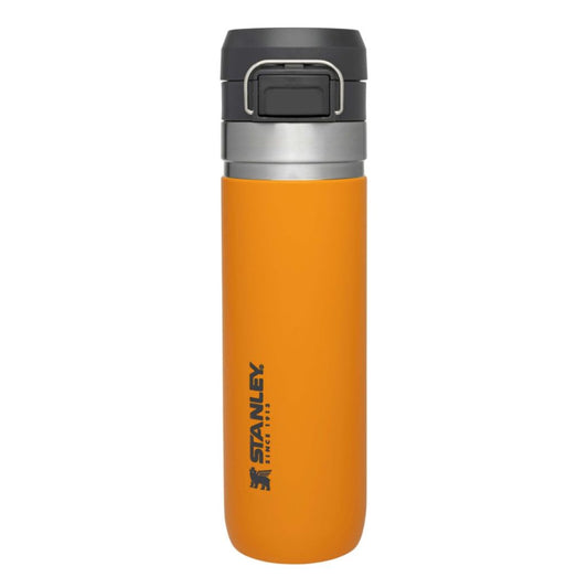 Orange Stanley insulated mug with a black lid on a white background