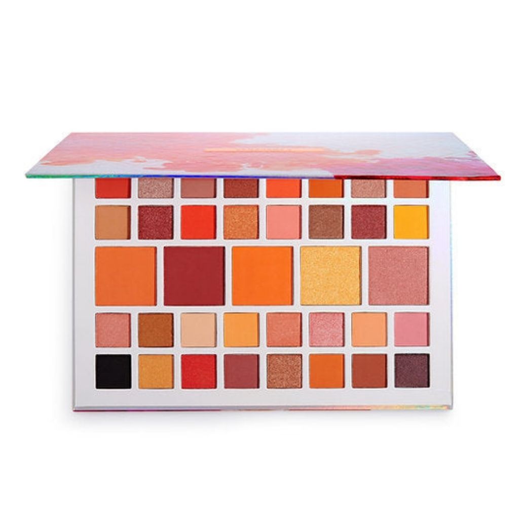 Makeup palette with various colorful shades on a white background