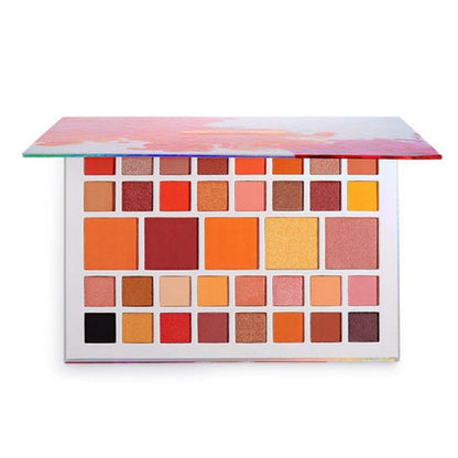 Makeup palette with various colorful shades on a white background