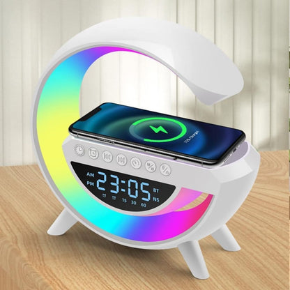 White moon-shaped clock with digital display and wireless charging pad on a wooden surface.