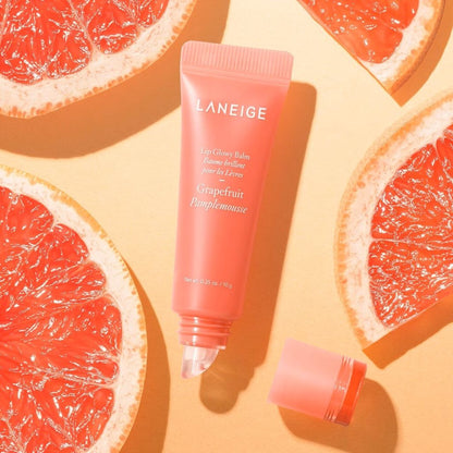 Laneige lip balm tube with grapefruit slices on a yellow background