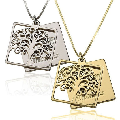 Two tree-shaped pendants, one silver and one gold, on white background
