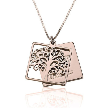 Rose gold necklace with tree pendant on a white background