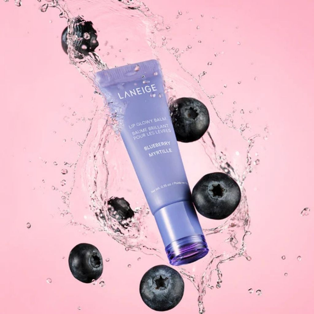 Laneige lip balm with blueberries on a pink background