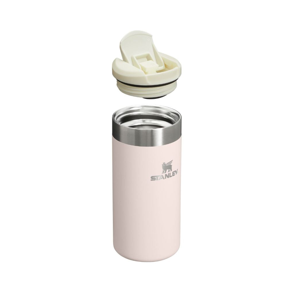 Pink Stanley tumbler with a white lid on a white background