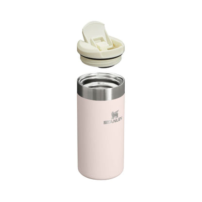 Pink Stanley tumbler with a white lid on a white background
