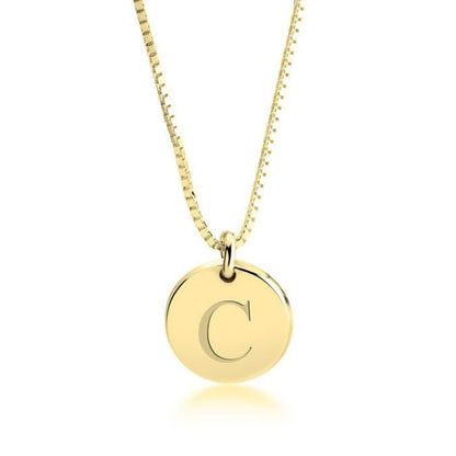 Gold necklace with a round pendant featuring the letter 'C' on a white background
