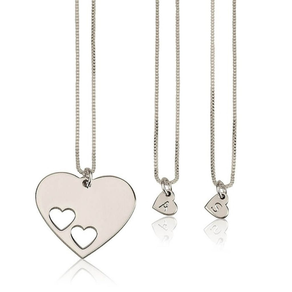 Three silver heart-shaped necklaces on a white background