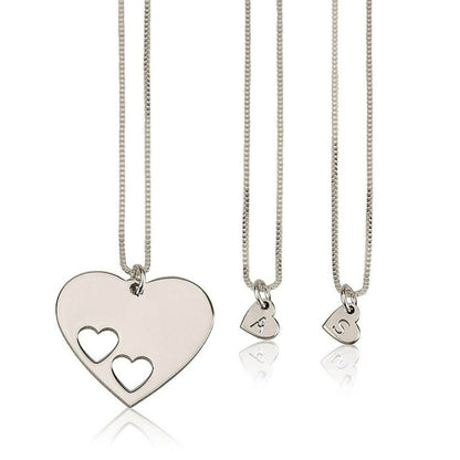 Three silver heart-shaped necklaces on a white background
