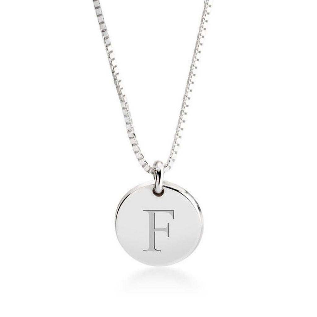 Silver necklace with a round pendant featuring the letter 'F' on a white background