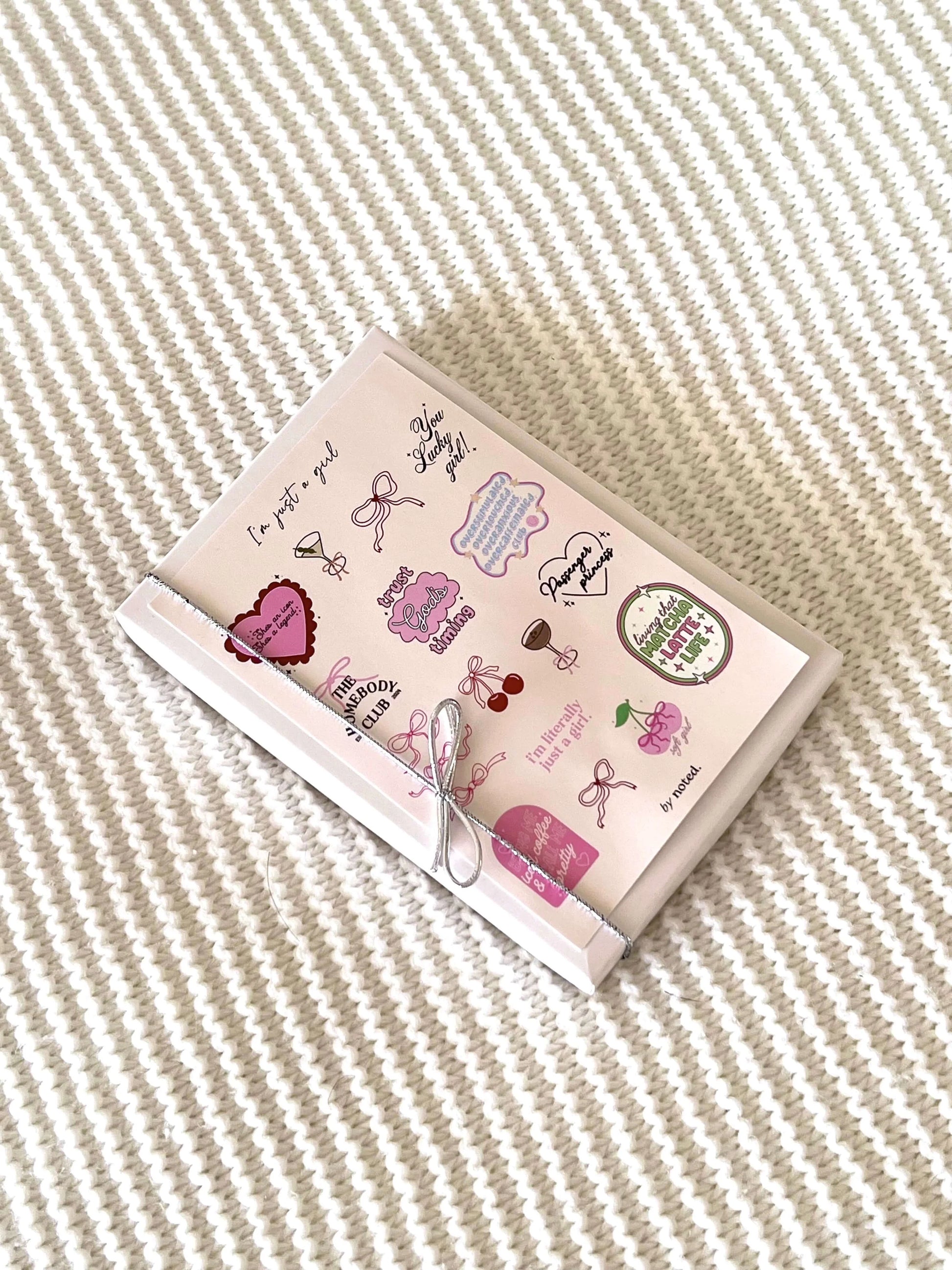 Small notebook with decorative stickers on a textured surface
