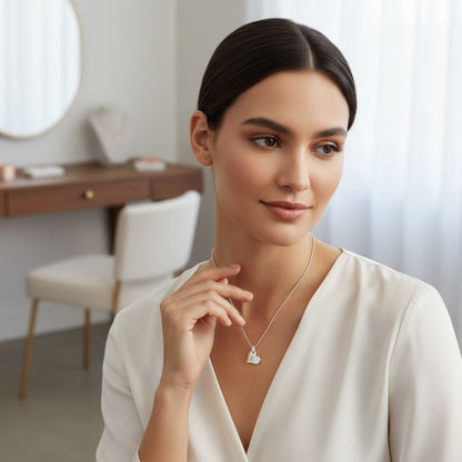 Woman wearing a necklace in a softly lit room