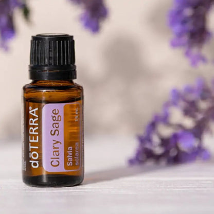 doTERRA Clary Sage essential oil bottle with blurred purple flowers in the background